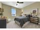 Bedroom with queen bed, neutral walls, and a window at 5177 Blanket Flower St, Apopka, FL 32712