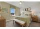 Cozy bedroom with a queen-size bed, neutral tones, and a window overlooking the landscape at 5177 Blanket Flower St, Apopka, FL 32712