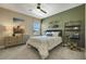 Stylish bedroom featuring a ceiling fan, neutral color scheme, and unique skateboard decor at 5177 Blanket Flower St, Apopka, FL 32712