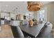 Open-concept dining area with woven pendant lighting, adjacent to the living room and kitchen at 5177 Blanket Flower St, Apopka, FL 32712