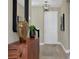 Entryway with tile floor, modern artwork, and a wooden console table at 5177 Blanket Flower St, Apopka, FL 32712