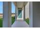 View of covered entryway featuring a turquoise door and well-kept landscaping at 5177 Blanket Flower St, Apopka, FL 32712