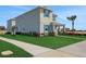 Well-maintained home featuring manicured landscaping and a vibrant palm tree at 5177 Blanket Flower St, Apopka, FL 32712