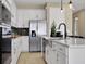 Well-appointed kitchen featuring stainless steel appliances and modern white cabinetry at 5177 Blanket Flower St, Apopka, FL 32712