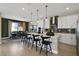 Spacious kitchen island with modern pendant lights overhanging a breakfast bar with seating at 5177 Blanket Flower St, Apopka, FL 32712