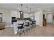 Well-lit kitchen featuring pendant lights, a kitchen island with seating, and stainless steel appliances at 5177 Blanket Flower St, Apopka, FL 32712