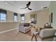 Upstairs living room with neutral color palette, ceiling fan, and natural light at 5177 Blanket Flower St, Apopka, FL 32712