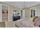 Bright main bedroom featuring a chandelier, closet, and a doorway to an en-suite bathroom at 5177 Blanket Flower St, Apopka, FL 32712