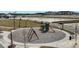 Outdoor playground with swings, slide, and climbing structure in a recreational space at 5177 Blanket Flower St, Apopka, FL 32712