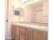 Bathroom featuring double sink vanity and a large mirror at 651 Timbercrest Dr, Leesburg, FL 34748