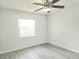 Bright bedroom featuring a window and ceiling fan at 651 Timbercrest Dr, Leesburg, FL 34748