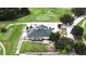 Aerial view of golf clubhouse overlooking a golf course with mature trees at 651 Timbercrest Dr, Leesburg, FL 34748