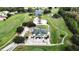 Aerial view of golf course clubhouse with ample parking, landscaped grounds, and putting green at 651 Timbercrest Dr, Leesburg, FL 34748