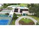 Community clubhouse featuring tennis courts, shuffleboard, a pool, and well-maintained landscaping at 651 Timbercrest Dr, Leesburg, FL 34748