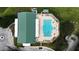 Aerial view of a community pool with lounge chairs, lush landscaping, and a nearby community building at 651 Timbercrest Dr, Leesburg, FL 34748