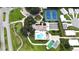 Aerial view of community with tennis courts, shuffleboard, community pool, and lush landscaping at 651 Timbercrest Dr, Leesburg, FL 34748