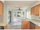 Eat-in kitchen area filled with natural light, features updated floors and sliding door access at 651 Timbercrest Dr, Leesburg, FL 34748