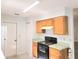 Bright kitchen with wood cabinets, smooth countertops, and modern electric range at 651 Timbercrest Dr, Leesburg, FL 34748