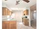 Functional kitchen equipped with wooden cabinets, black appliances, and light green countertops at 651 Timbercrest Dr, Leesburg, FL 34748