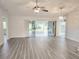 Bright living room features new wood floors, ceiling fan, and sliding glass doors to backyard at 651 Timbercrest Dr, Leesburg, FL 34748
