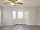 Sunlit living room features stylish ceiling fan and large bay window at 651 Timbercrest Dr, Leesburg, FL 34748