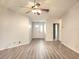Open-concept living space with light-colored floors leading to front door and a hallway at 651 Timbercrest Dr, Leesburg, FL 34748