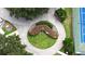 Aerial view of a landscaped roundabout near a tennis court in a community setting at 651 Timbercrest Dr, Leesburg, FL 34748