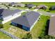 Aerial view of a single story home with a screened in patio and a large backyard at 7732 Sloewood Dr, Leesburg, FL 34748