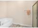 Bathroom featuring a tub, a glass door shower, tile floors and a scale at 7732 Sloewood Dr, Leesburg, FL 34748