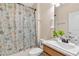Bathroom featuring a shower and tub with a decorative seahorse shower curtain at 7732 Sloewood Dr, Leesburg, FL 34748