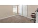 This is a simple bedroom with neutral paint, carpet and a large closet at 7732 Sloewood Dr, Leesburg, FL 34748