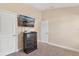 Bedroom featuring neutral paint, carpet, a dresser with TV and two door ways at 7732 Sloewood Dr, Leesburg, FL 34748