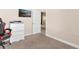 Bedroom featuring neutral paint, carpet, a closet, dresser, TV and gaming chair at 7732 Sloewood Dr, Leesburg, FL 34748
