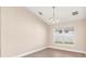 Bright dining room with hardwood flooring, a modern chandelier, and a large window at 7732 Sloewood Dr, Leesburg, FL 34748