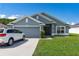 Attractive single-Gathering home featuring a well-manicured lawn, a two-car garage, and a welcoming entrance at 7732 Sloewood Dr, Leesburg, FL 34748