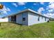 Back of home features a screened in patio and blue paint at 7732 Sloewood Dr, Leesburg, FL 34748