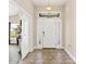 Inviting foyer with decorative tile flooring, a charming light fixture, and neutral wall colors at 7732 Sloewood Dr, Leesburg, FL 34748