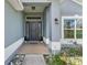 Welcoming front entrance with modern door, decorative stonework, and ample natural light at 7732 Sloewood Dr, Leesburg, FL 34748