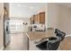 Eat-in kitchen features stainless appliances, granite counters, breakfast bar, and ample natural light at 7732 Sloewood Dr, Leesburg, FL 34748