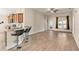 Open concept with island seating in kitchen, hardwood floors, and abundant natural light at 7732 Sloewood Dr, Leesburg, FL 34748