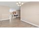 Open-concept living area with hardwood floors leading into the kitchen and dining spaces at 7732 Sloewood Dr, Leesburg, FL 34748