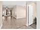 Spacious living room with hardwood floors, natural light, and an open layout to a connecting room at 7732 Sloewood Dr, Leesburg, FL 34748