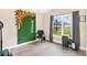 Bright office with window, decorated wall, stylist chair, and wood-look tile floors at 7732 Sloewood Dr, Leesburg, FL 34748