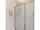 Modern shower featuring a glass sliding door, tile walls and neutral paint at 7732 Sloewood Dr, Leesburg, FL 34748