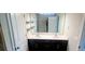 Bathroom vanity with double sinks, dark cabinets and shelving at 1867 Holden Ridge Lane, Clermont, FL 34715
