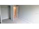 Bedroom with light gray walls and two open doors at 1867 Holden Ridge Lane, Clermont, FL 34715