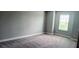 Neutral-toned bedroom with a large window at 1867 Holden Ridge Lane, Clermont, FL 34715