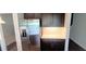 Modern kitchen featuring stainless steel refrigerator and dark cabinets at 1867 Holden Ridge Lane, Clermont, FL 34715
