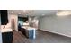 Open living area featuring a kitchen with an island and dark flooring at 1867 Holden Ridge Lane, Clermont, FL 34715