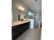 Well-lit bathroom featuring a glass shower and double sink at 2324 Juniper Berry Dr, Minneola, FL 34715